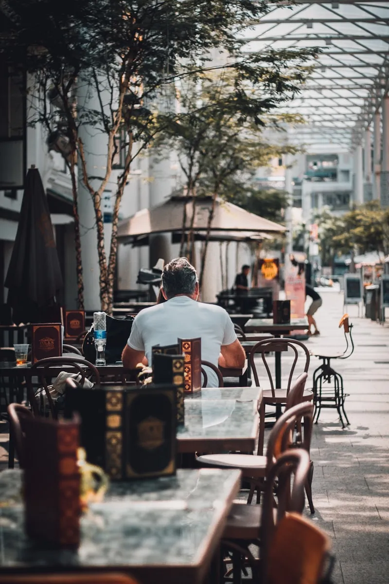 man sitting on chair near tree