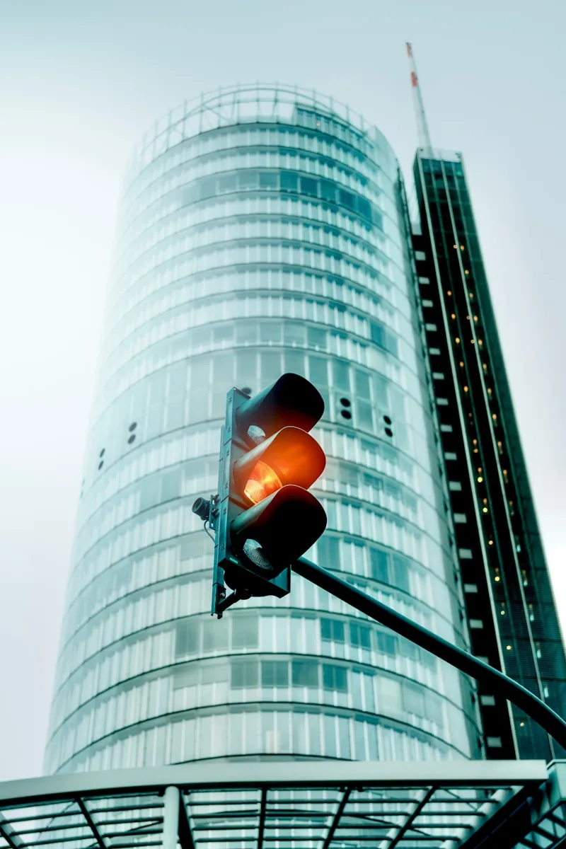 A traffic light in front of a tall building