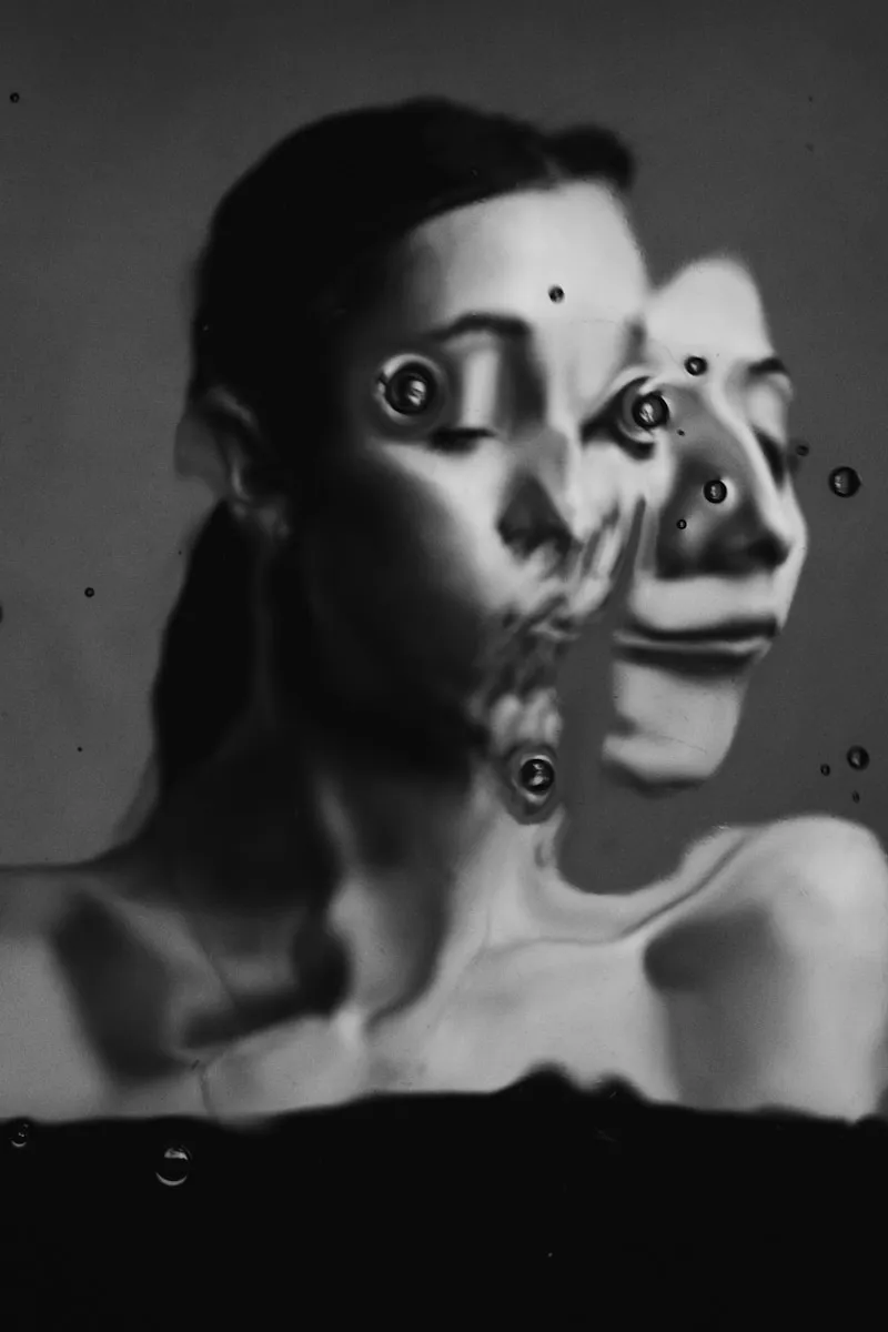 A black and white photo of a woman with two faces