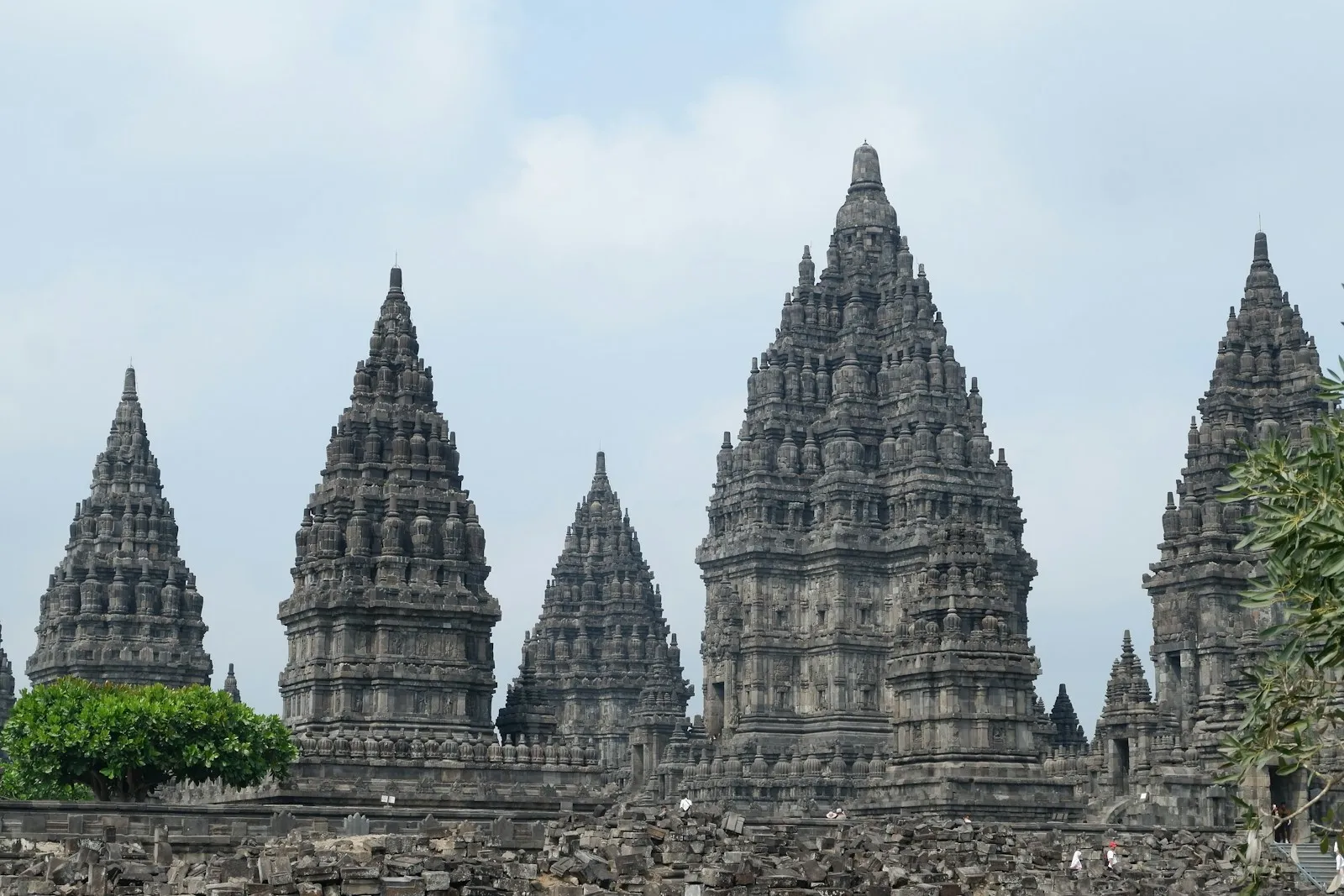 a large group of stone structures with trees in the foreground