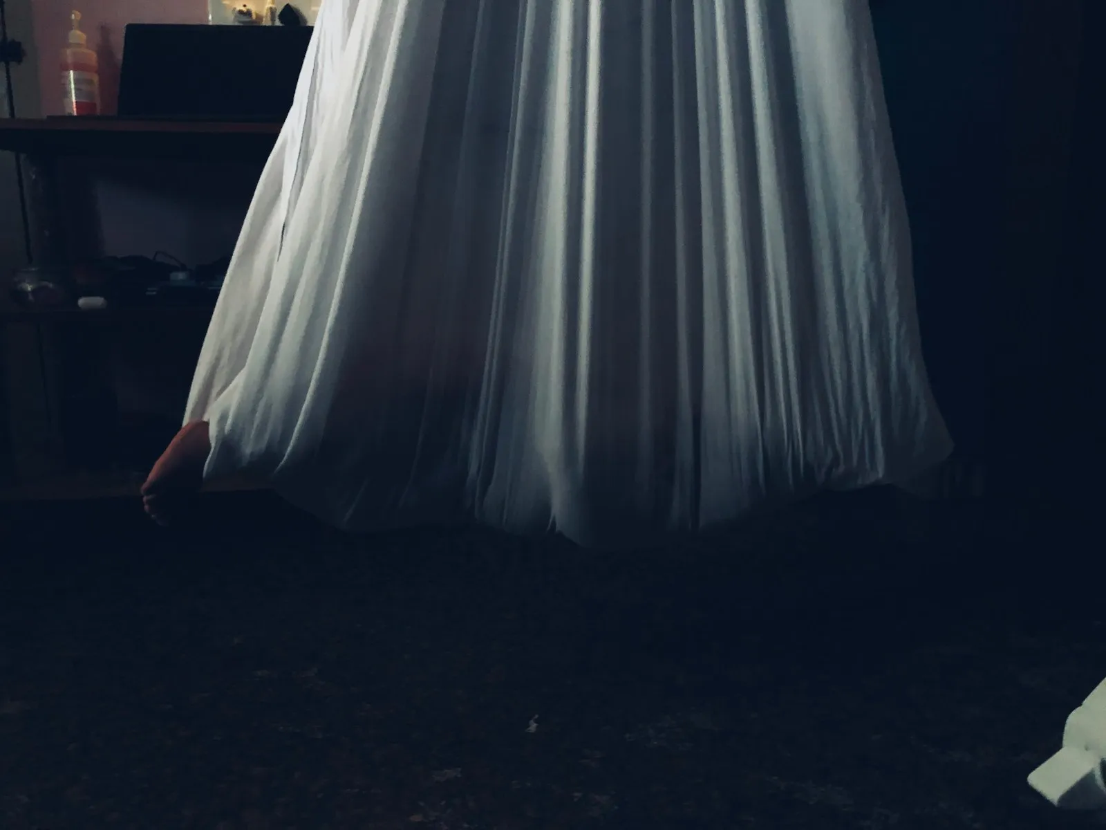 woman in white dress standing on black floor