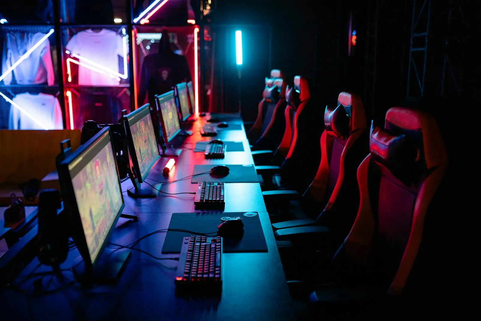 High-tech gaming setup with PCs, RGB lighting, and gaming chairs in a gaming house.