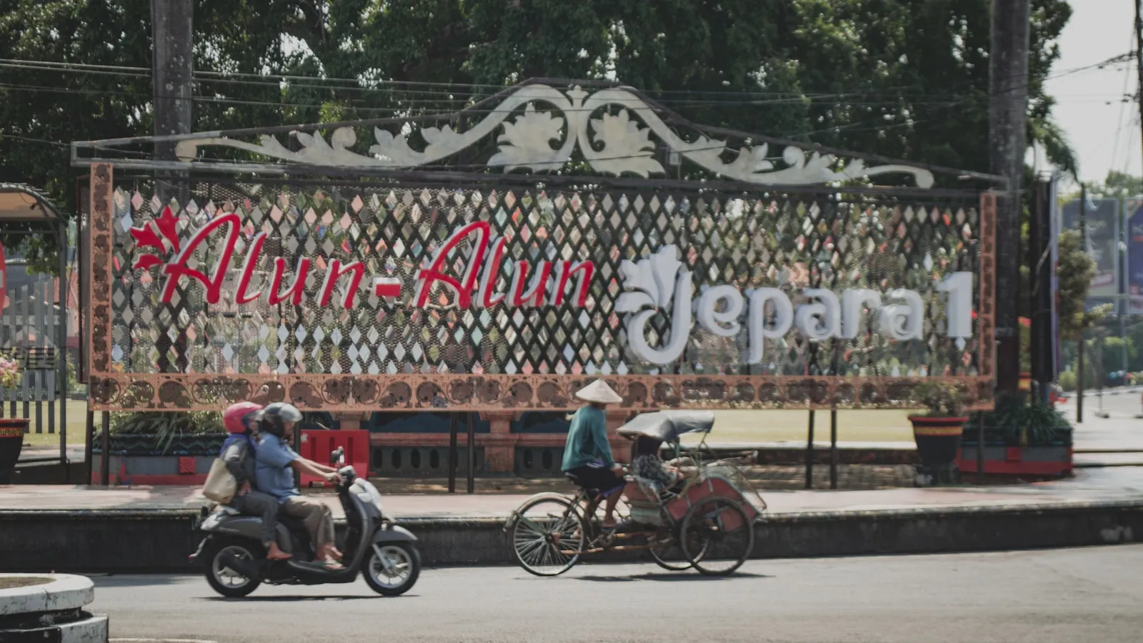 a group of people riding scooters down a street